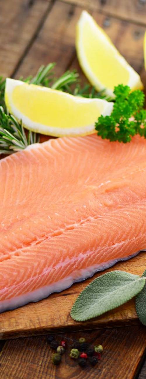 Fish fillet with lemons on a cutting board